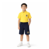 Boy wearing yellow short-sleeve school polo shirt with chest crest and navy shorts