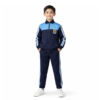 Boy in navy school tracksuit uniform with sky-blue shoulder panels and side stripes, full-zip jacket and track pants