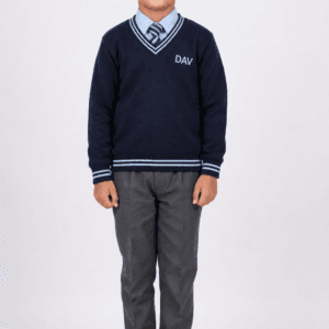 Indian child wearing navy blue DAV full sleeve V-neck school sweater with grey trousers and striped school tie on studio background
