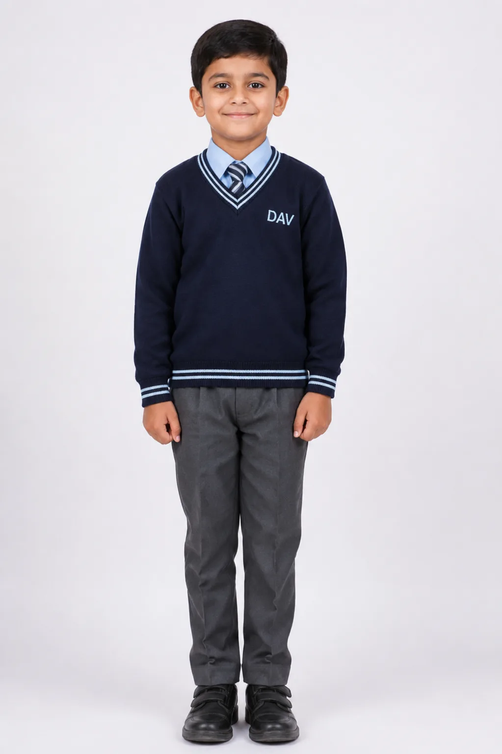 dav-full-sleeve-school-sweater-front-view Indian child wearing navy blue DAV full sleeve V-neck school sweater with grey trousers and striped school tie on studio background