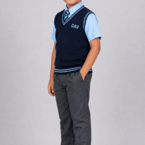 Indian school boy wearing navy blue DAV half sleeve V-neck school sweater with light blue shirt and grey trousers in studio shoot