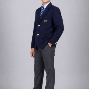 Side angle studio photo of Indian boy wearing navy blue DAV school blazer with tie and grey school trousers