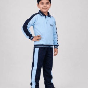 Indian boy wearing DAV school winter tracksuit with navy blue lowers and light blue sweatshirt in studio side pose